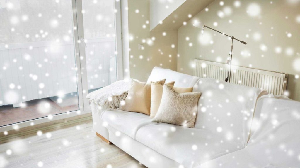 Cozy living room with white sofa in snowfall.